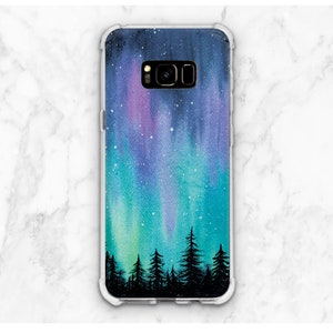 May include: A clear phone case with a watercolor design of a night sky with green, blue, and purple aurora borealis and a silhouette of a forest of trees at the bottom.