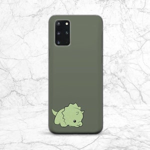 May include: A green phone case with a cute cartoon green dinosaur on it.
