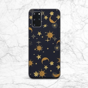 May include: A black phone case with a gold celestial pattern. The pattern includes stars, moons, and suns.