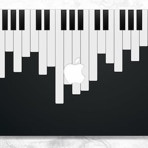 Puede incluir: Un ordenador portátil negro con un diseño de teclado de piano blanco en la tapa. El logotipo de Apple es visible en el centro de la tapa.