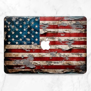 May include: Laptop skin featuring a distressed American flag design. The skin has a weathered appearance with peeling paint, showcasing the red and white stripes and blue field with white stars. A white Apple logo is visible.