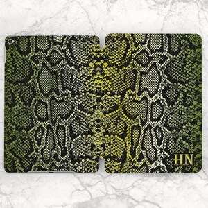 May include: A green and yellow snake skin pattern iPad case with the initials "HN" in the bottom right corner.