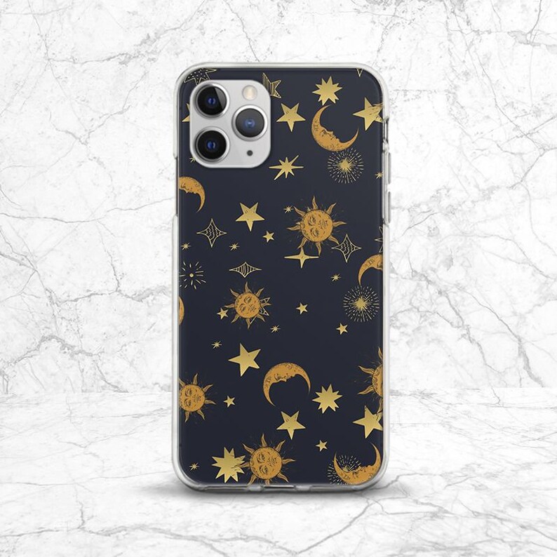 May include: A clear phone case with a dark blue background and a gold pattern of stars, moons, and suns.