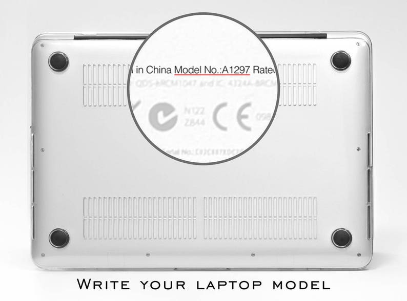 May include: Close-up of the bottom of a silver laptop with the text "in China Model No.: A1297 Rate" visible. The laptop has a silver finish and a black rubber strip around the edge.