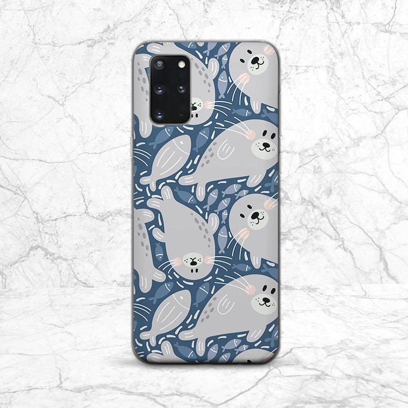 May include: A blue phone case with a pattern of gray seals and white fish. The case has a cutout for the camera lens.