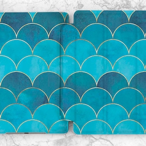 May include: A blue and gold iPad case with a geometric pattern of overlapping scales.