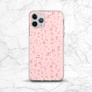 May include: A clear phone case with a pink background and a pattern of red and pink musical notes.