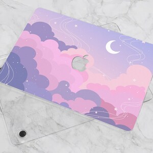 May include: A clear plastic laptop case with a colorful design featuring pink and purple clouds, stars, and a crescent moon. The design is printed on the back of the case.