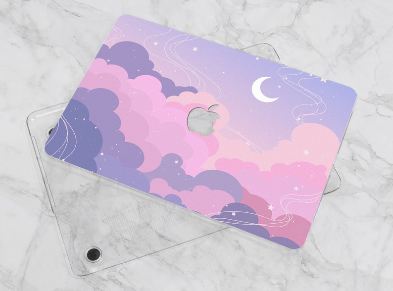 May include: A clear plastic laptop case with a colorful design featuring pink and purple clouds, stars, and a crescent moon. The design is printed on the back of the case.