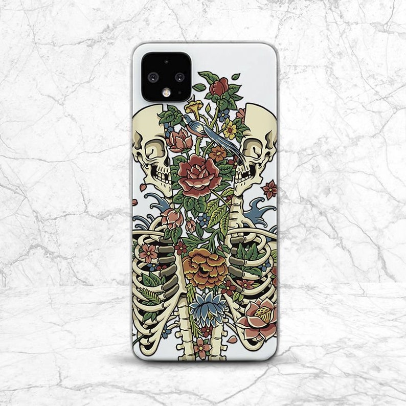 May include: A white phone case with a colorful floral design featuring a skeleton with a bird perched on a flower. The design is a mix of red, pink, blue, green, and yellow flowers.