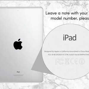 May include: A white iPad with a black Apple logo on the back. The text "iPad" is printed on the back of the device. The text "Designed by Apple in California Assembled in China Model A1823 FCC ID:BCGA1823 IC:579C-A1823 Serial: DMPHJ7JHDJ8T FCXCEO" is printed on the back of the device.