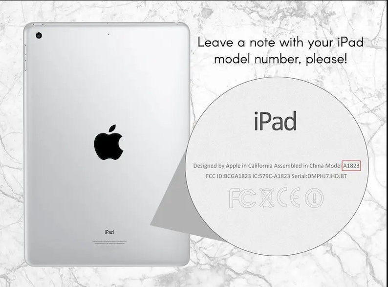 May include: A white iPad with a black Apple logo on the back. The text "iPad" is printed on the back of the device. The text "Designed by Apple in California Assembled in China Model A1823 FCC ID:BCGA1823 IC:579C-A1823 Serial: DMPHJ7JHDJ8T FCXCEO" is printed on the back of the device.