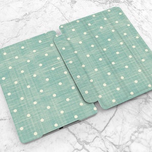 May include: A teal blue iPad case with a white polka dot pattern. The case has a linen texture.
