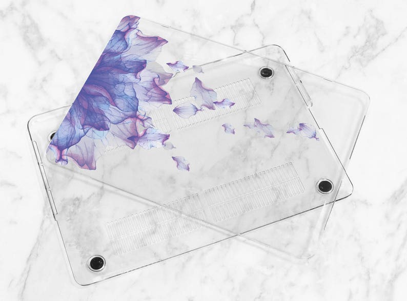 May include: A clear plastic laptop case with a floral design. The design features purple and blue watercolor flowers on a white background.