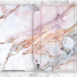 May include: A pink and white marble iPad case with a folio style cover. The case has a subtle pink and gold veining pattern.
