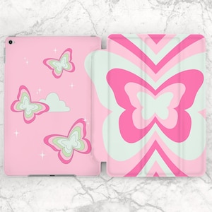 May include: Pink tablet case with a butterfly design. The case is open, revealing the interior and exterior designs. The exterior features a large butterfly design in pink and white. The interior has pink butterflies and a cloud.