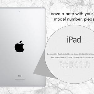 May include: A white iPad with a black Apple logo on the back. The text "iPad" is printed on the back of the device. The text "Designed by Apple in California Assembled in China Model A1823 FCC ID:BCGA1823 IC:579C-A1823 Serial:DMPHJ7JHDJ8T FCXCEO" is printed on the back of the device.