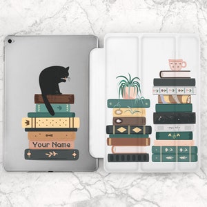 May include: A white iPad case with a black cat sitting on a stack of books. The case has a personalized name, "Your Name", on the front. The back of the case has a stack of books with a potted plant and a cup of tea.