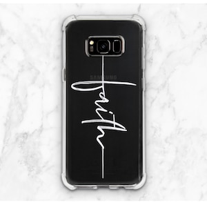 May include: A clear phone case with a black back and a white cross with the word "faith" written on it.