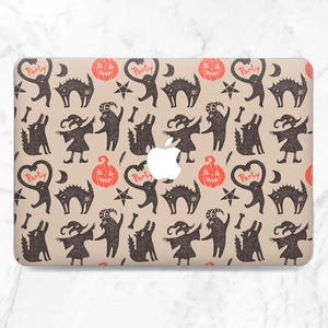 May include: A beige laptop case featuring a repeating Halloween-themed pattern. The design includes black cats, pumpkins, stars, bones, and figures with arms raised. The word "Party" is written in a heart shape. The Apple logo is visible.
