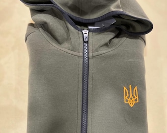 Green militaryhoodie with Ukrainian Trident. Stylization for traditional authentic clothes - vyshyvanka. Coat of arms of Ukraine