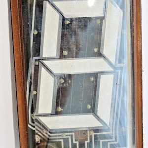 May include: A vintage seven-segment LED display with a brown plastic frame and a clear plastic cover. The display shows the number "8" in white.