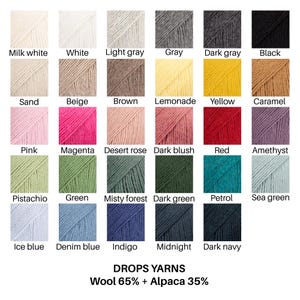 May include: A color chart of Drops yarns composed of 65% wool and 35% alpaca. The grid displays 29 distinct yarn samples labeled with names including Milk white, White, Light gray, Gray, Dark gray, Black, Sand, Beige, Brown, Lemonade, Yellow, Caramel, Pink, Magenta, Desert rose, Dark blush, Red, Amethyst, Pistachio, Green, Misty forest, Dark green, Petrol, Sea green, Ice blue, Denim blue, Indigo, Midnight, and Dark navy.