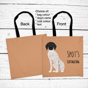 May include: A brown tote bag with black handles. The front of the bag features a black and white illustration of a dog with the text "SPOT'S COTTAGE BAG".