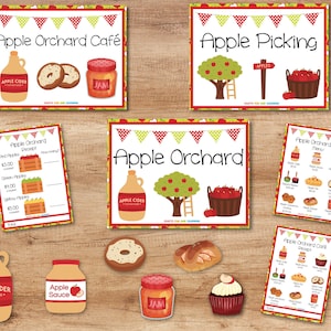 May include: A set of printable signs for an apple orchard themed party or event. The signs include a cafe menu, a receipt, a price list for apples, and a sign for apple picking. The signs are decorated with red and green apples, a ladder, and a basket of apples.