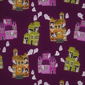 May include: A dark purple fabric featuring a repeating pattern of haunted houses in shades of pink, olive green, and orange. The houses have multiple windows and towers, and are surrounded by numerous small, white, cartoon-style ghost figures.