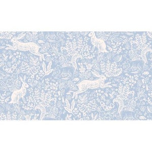 May include: A light blue and white patterned fabric featuring a repeating design of rabbits, squirrels, and floral elements. The illustrations are in white, set against a soft blue background, creating a whimsical and nature-inspired aesthetic.