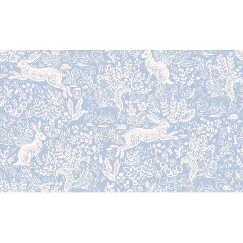 May include: A light blue and white patterned fabric featuring a repeating design of rabbits, squirrels, and floral elements. The illustrations are in white, set against a soft blue background, creating a whimsical and nature-inspired aesthetic.
