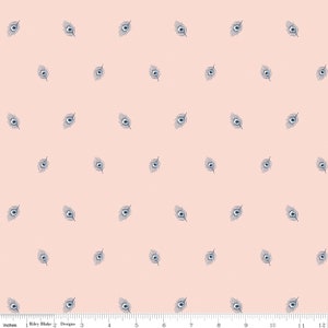 May include: A fabric with a repeating pattern of navy blue peacock feather designs on a light peach background. The fabric is measured in inches, with a ruler along the bottom edge.