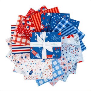 May include: A stack of square fabric swatches arranged in a circular fan pattern, tied with a white ribbon. The fabric features red, white, and blue patterns including American flags, fireworks, stars, stripes, and gingham checks on various backgrounds.