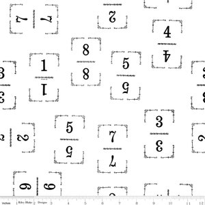 May include: White fabric with a repeating pattern of black numbers 1 through 9 in decorative frames. The numbers are in a stylized font and are surrounded by a simple border.