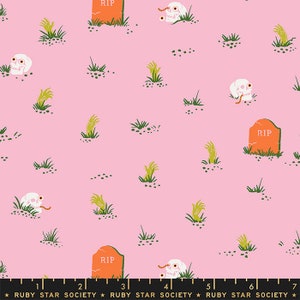 May include: Pink fabric with a repeating pattern of skulls, tombstones, and zombie hands. The tombstones are orange with the text "RIP" on them. The fabric has a ruler printed at the bottom with the text "Ruby Star Society".