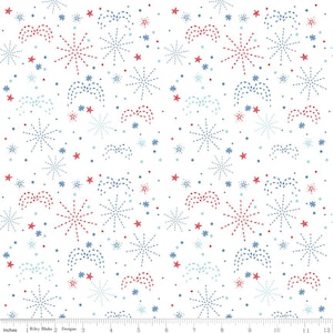 May include: White fabric with a repeating pattern of red, blue, and light blue fireworks, stars, and dots. The design includes various sizes and styles of fireworks and star shapes, creating a festive and celebratory theme. The fabric is measured in inches.
