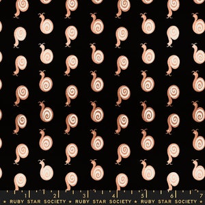 May include: Black fabric with a repeating pattern of copper-colored snails. The snails are stylized and have a white interior. The fabric has a ruler printed at the bottom with the text "RUBY STAR SOCIETY" repeated.