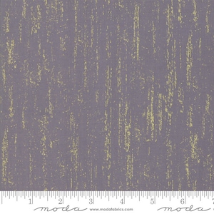 May include: A close-up of a gray fabric with a subtle gold metallic sheen. The fabric has a textured, brushed look, resembling a weathered surface. The fabric is measured in inches with a ruler at the bottom of the image.