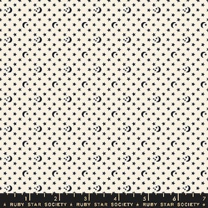 May include: Cream-colored fabric with a repeating pattern of navy blue stars and crescent moons. The design includes small and large stars, with the moons interspersed throughout. The text "RUBY STAR SOCIETY" is at the bottom.