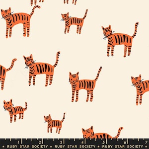 May include: Cream-colored fabric with a repeating pattern of orange and black tiger illustrations. The tigers are stylized with black stripes and whiskers. The text "RUBY STAR SOCIETY" is at the bottom.