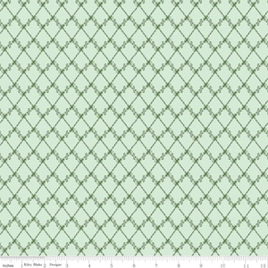 May include: A light green fabric with a repeating diamond pattern. The diamonds are formed by dark green lines with decorative flourishes at the intersections. The fabric is measured in inches along the bottom edge.