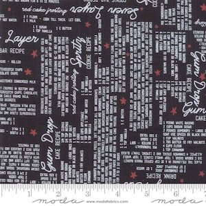 May include: Black fabric with white text featuring recipes for Layer Bar, Gum Drop Cake, and Spritz Cookies. The fabric also includes red star accents and the Moda Fabrics logo.