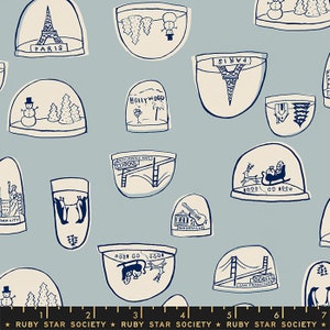 May include: A blue and white fabric with a repeating pattern of snow globes. Each snow globe features a different city or landmark, including Paris, Hollywood, Nashville, San Francisco, and New York City. The snow globes are filled with snow and have a variety of decorations, such as trees, penguins, and Santa Claus.