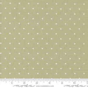 May include: A beige fabric with a white polka dot pattern. The fabric is shown with a ruler for scale.