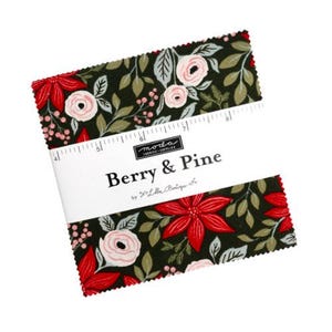 May include: A stack of fabric squares with a floral pattern featuring red poinsettias, pink roses, and green leaves on a dark background. The fabric is labeled "Berry & Pine" by Moda Fabrics.