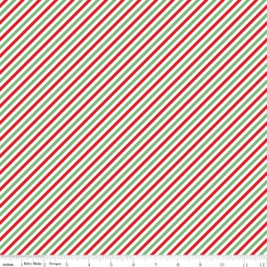 May include: A fabric with a diagonal stripe pattern in red, green, and white. The stripes are evenly spaced and run across the fabric. The image includes a ruler in inches along the bottom edge. The text "Riley Blake Designs" is also visible.