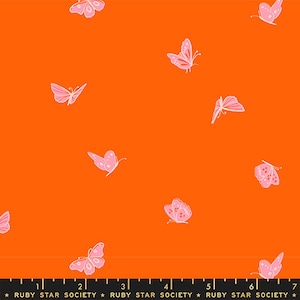 May include: Orange fabric with a repeating pattern of pink butterflies. The fabric has a ruler printed at the bottom with the text "RUBY STAR SOCIETY" repeated.