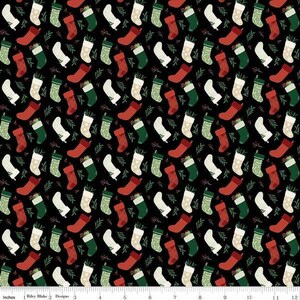 May include: A repeating pattern of Christmas stockings in red, green, and white on a black background. The stockings are decorated with various patterns and are interspersed with sprigs of greenery. A festive design.