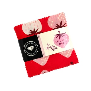 May include: A stack of red fabric squares with a strawberry pattern. The fabric is wrapped with a black band and a label that reads "strawberry" and "Ruby Star Society". Each square measures 2.5 inches.